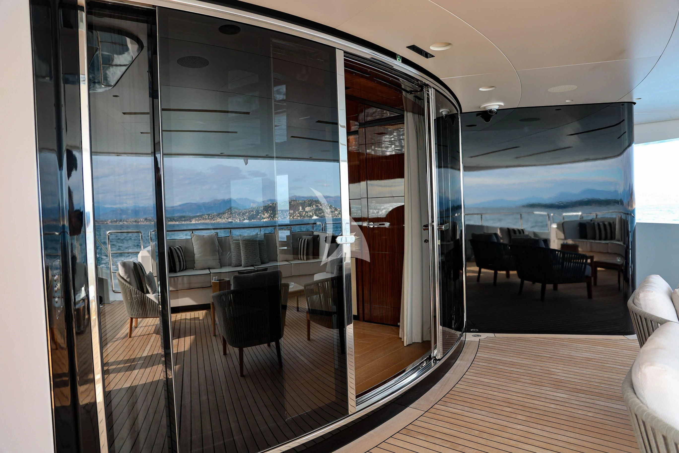 inside view of a room with a large glass door and a large window aboard MEDIALLY Yacht for Sale