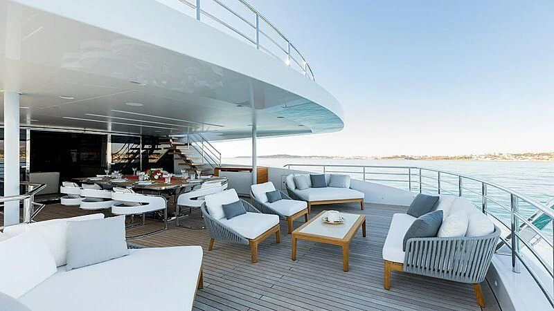 a patio with a table and chairs aboard MEDIALLY Yacht for Sale