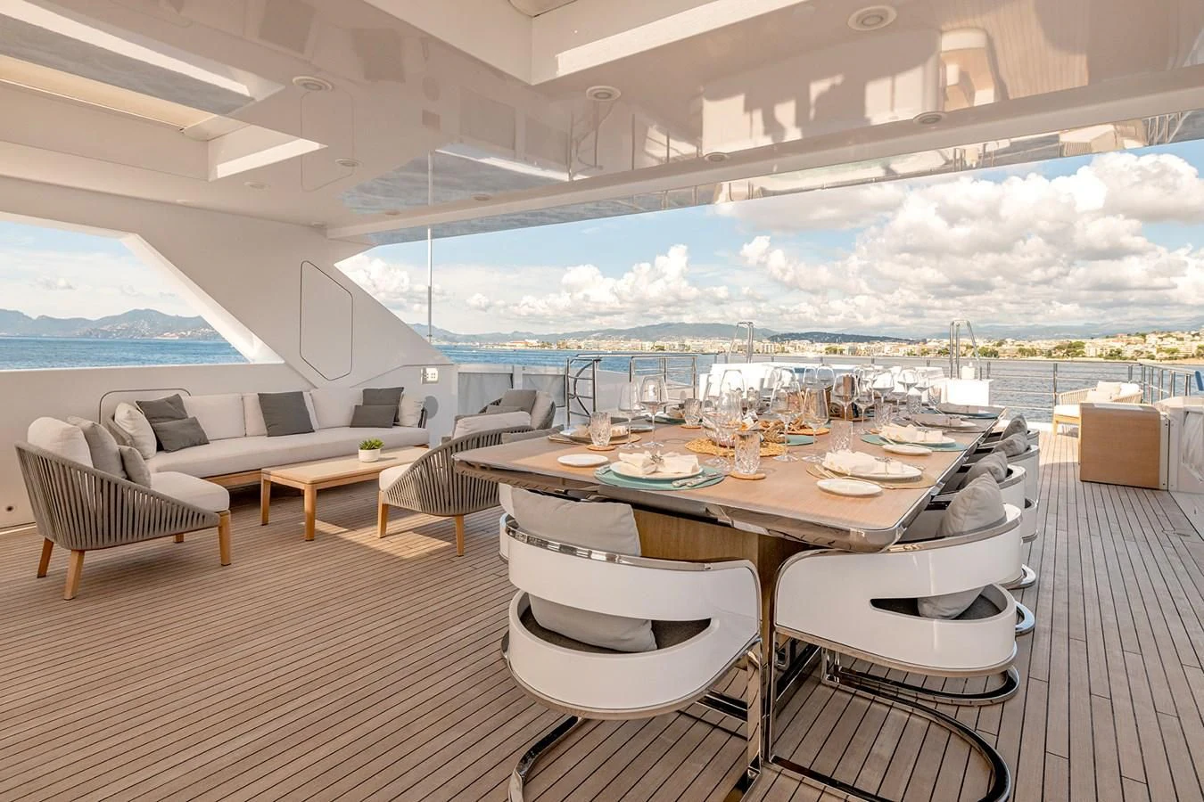 a room with a table chairs and a view of the city aboard MEDIALLY Yacht for Sale