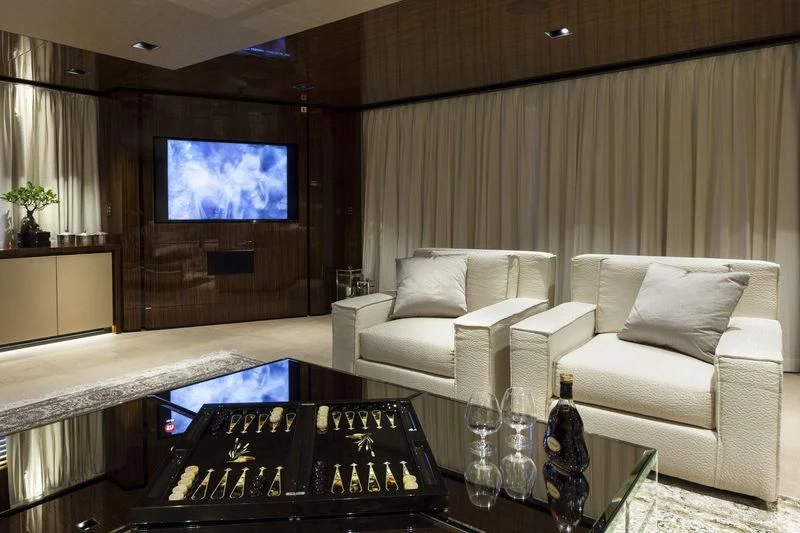 a living room with a large screen aboard MEDIALLY Yacht for Sale