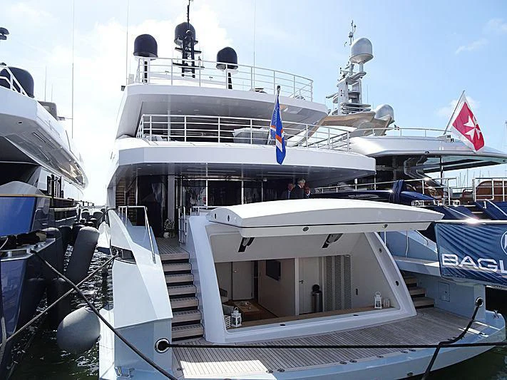 a large white boat with a flag on the front aboard MEDIALLY Yacht for Sale