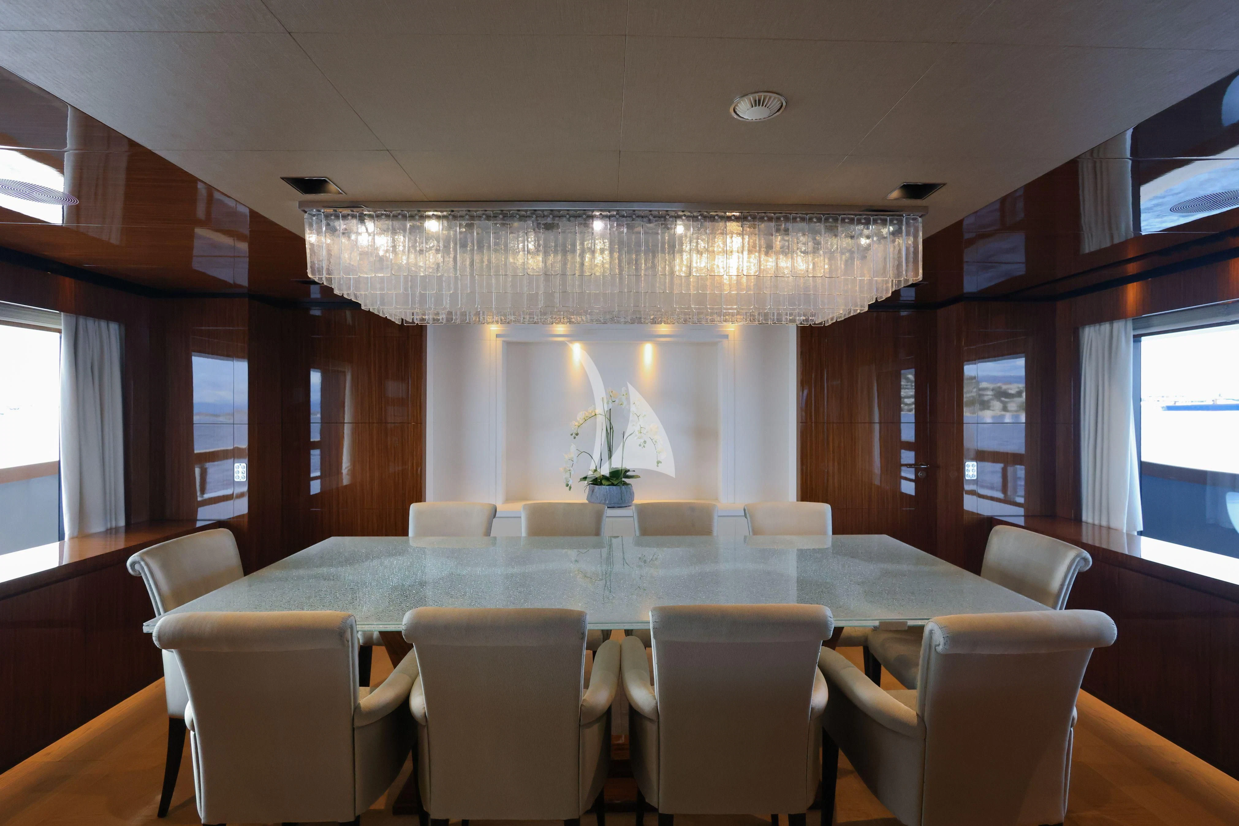 a large dining room with white chairs aboard MEDIALLY Yacht for Sale