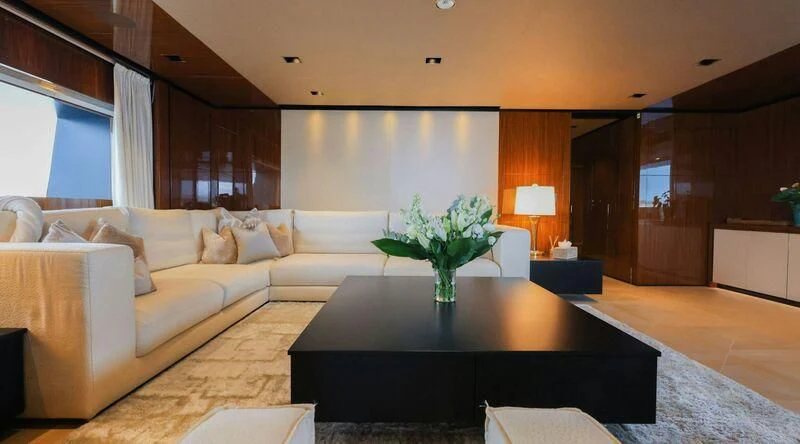 a living room with a large sofa aboard MEDIALLY Yacht for Sale