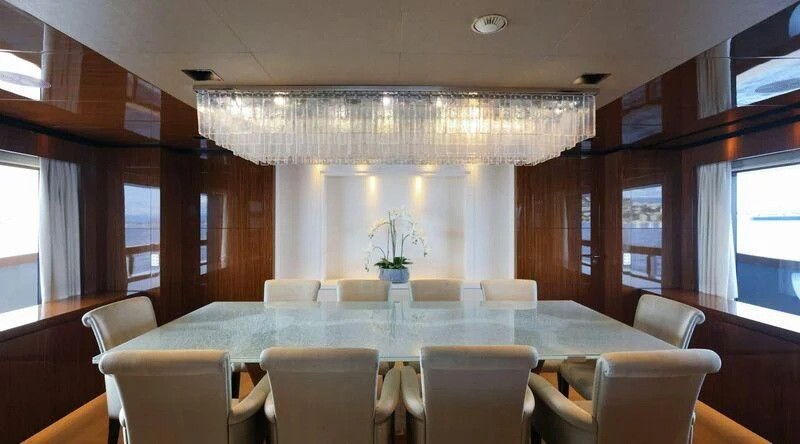 a room with a table and chairs aboard MEDIALLY Yacht for Sale