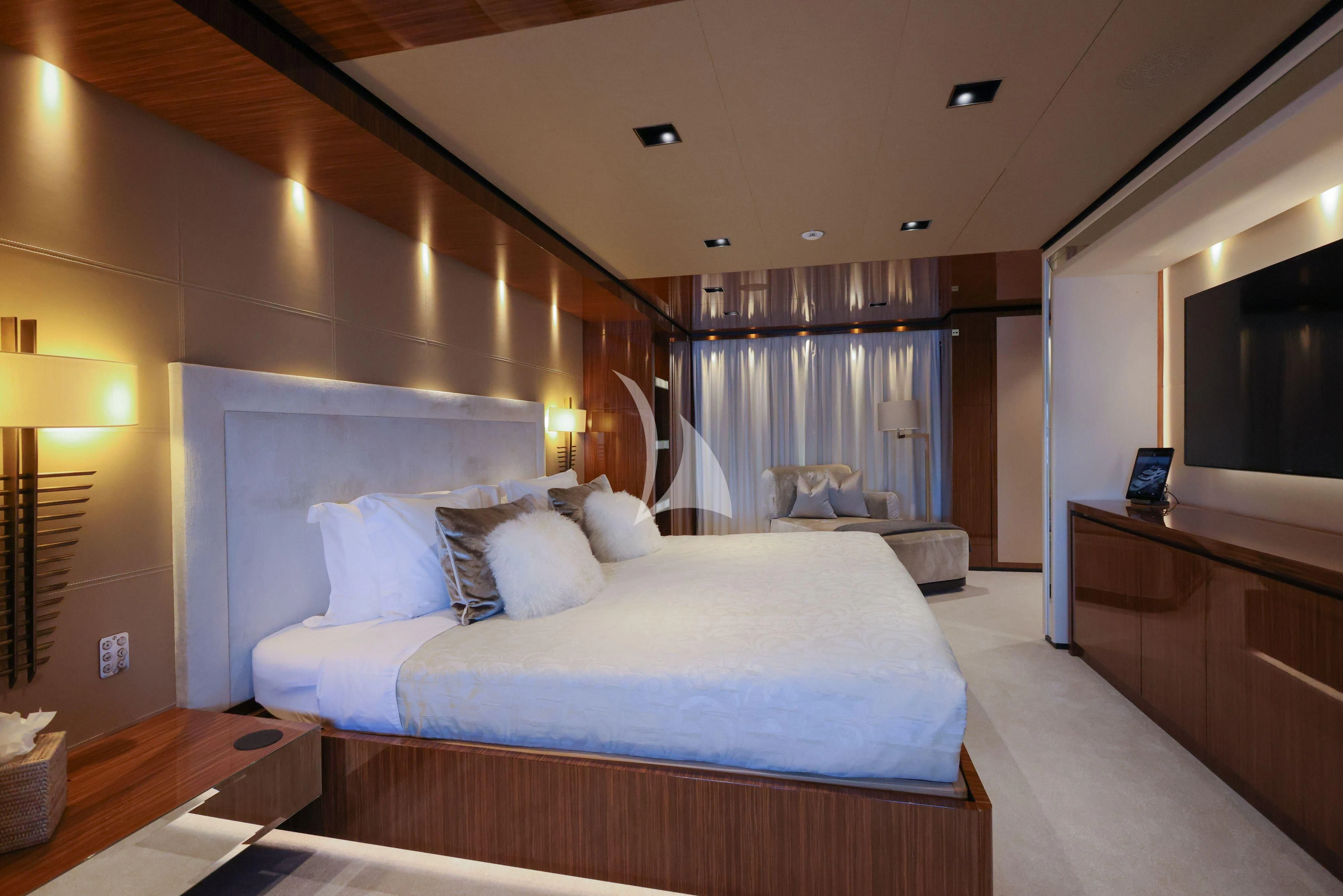 a bedroom with a bed and a desk aboard MEDIALLY Yacht for Sale