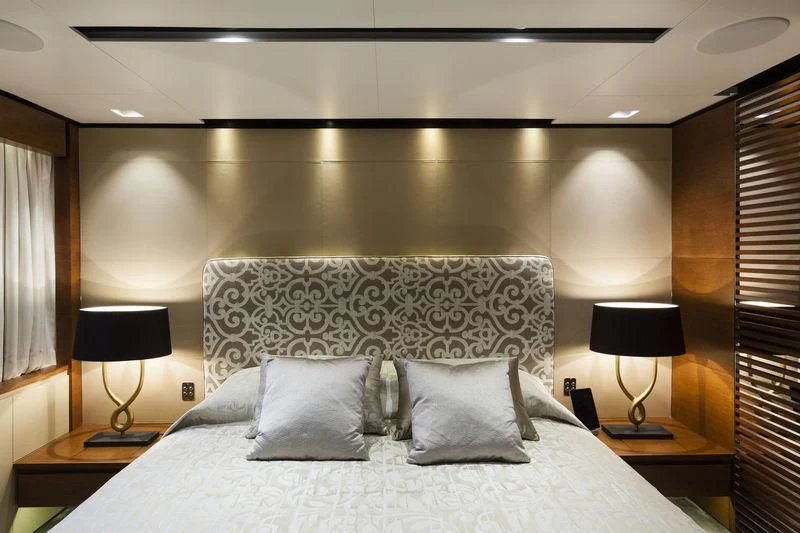 a bed with pillows and a lamp aboard MEDIALLY Yacht for Sale