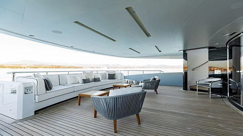 a room with a couch and a table and chairs aboard MEDIALLY Yacht for Sale