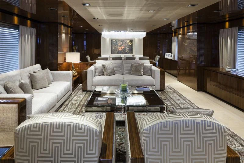 a living room with a large white sofa and a coffee table aboard MEDIALLY Yacht for Sale