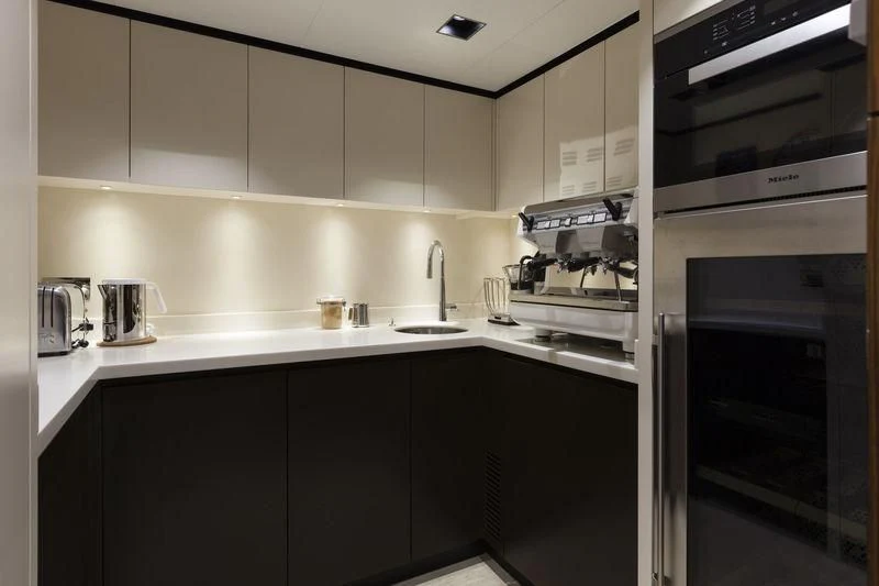 a kitchen with white cabinets aboard MEDIALLY Yacht for Sale