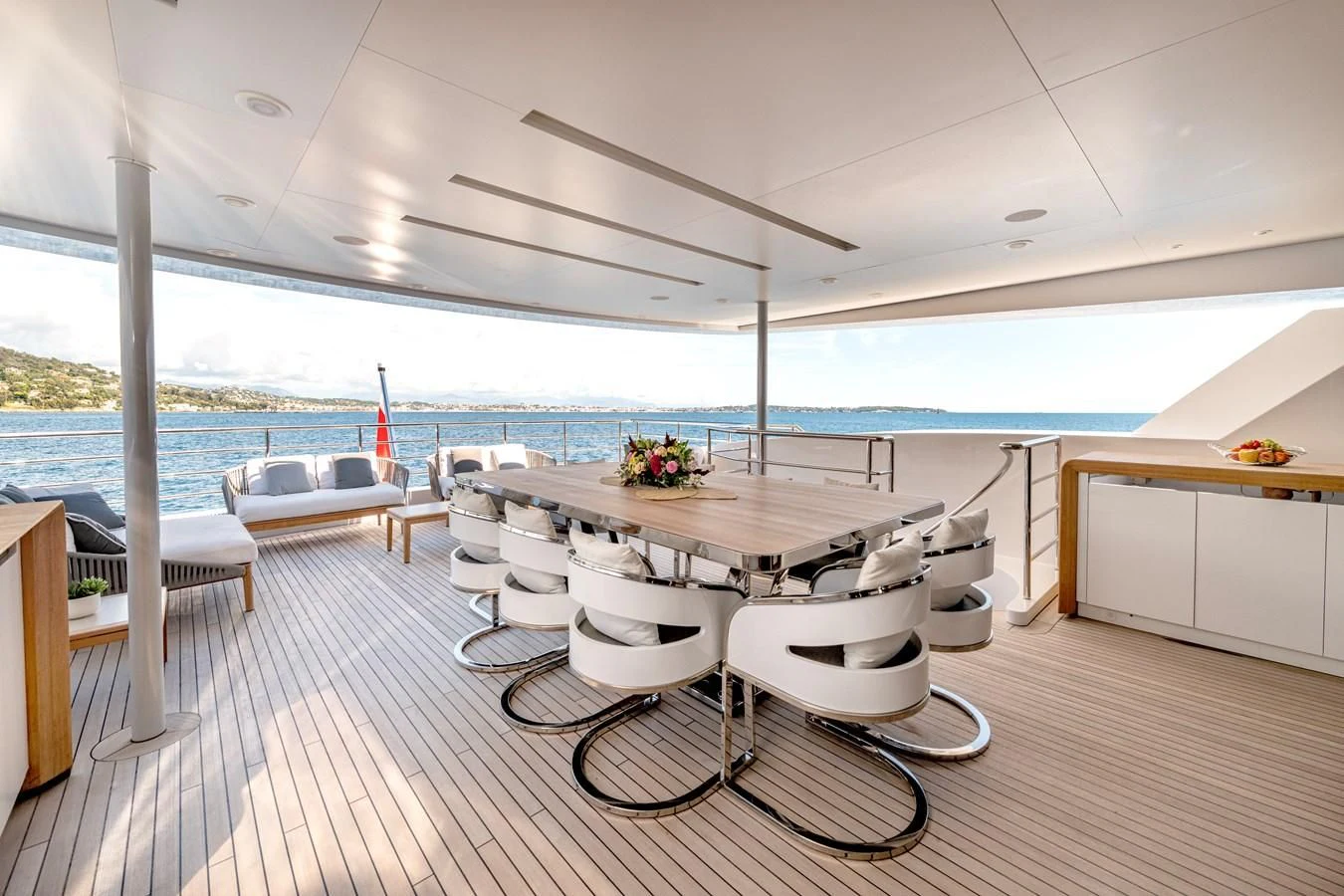 a room with a table chairs and a large body of water aboard MEDIALLY Yacht for Sale