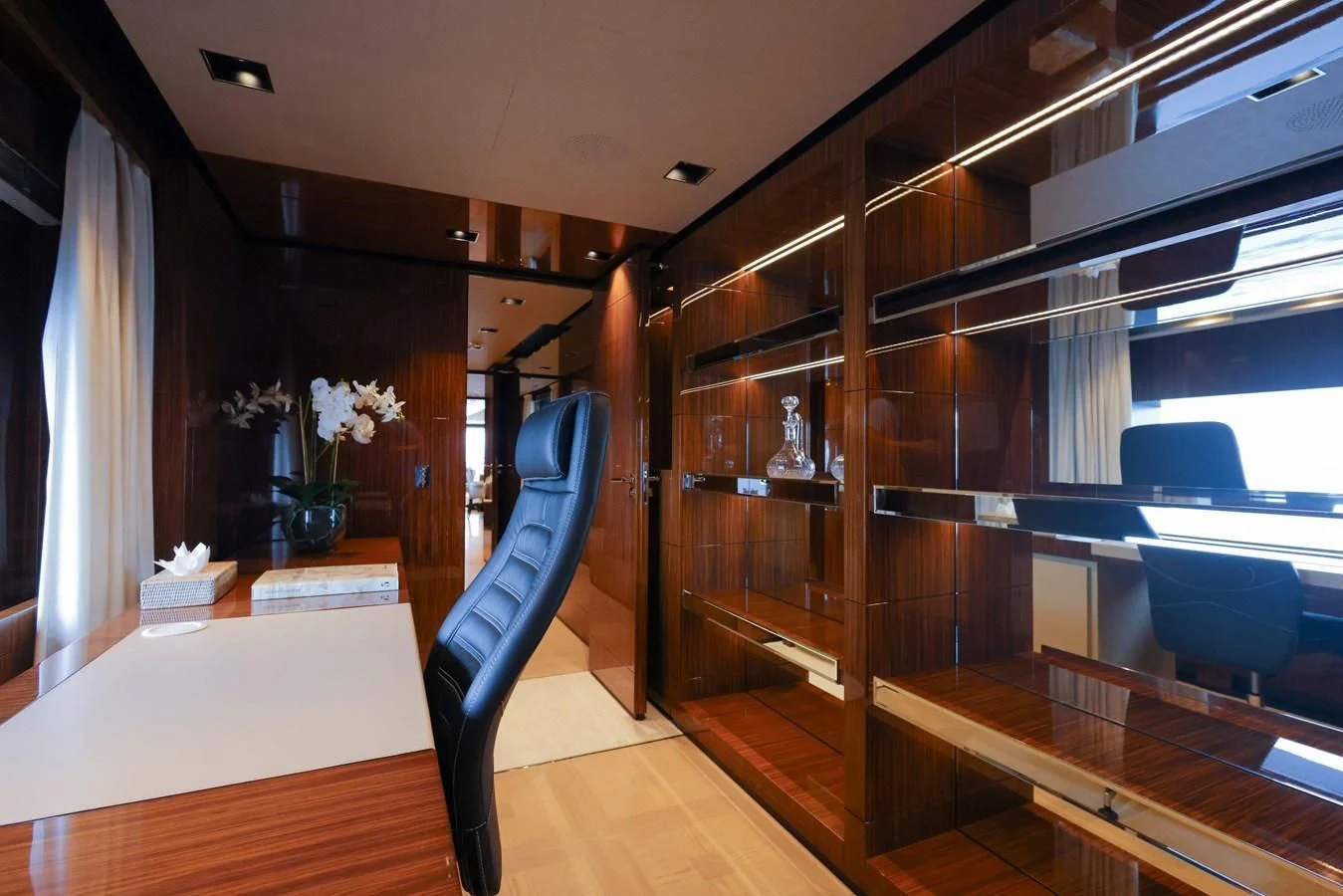 a room with a wood cabinet and a chair and a table aboard MEDIALLY Yacht for Sale