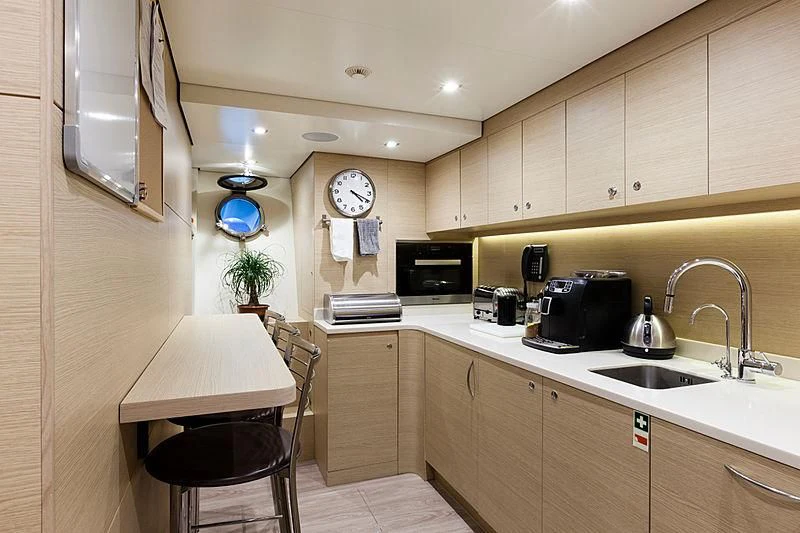a kitchen with a table and chairs aboard MEDIALLY Yacht for Sale