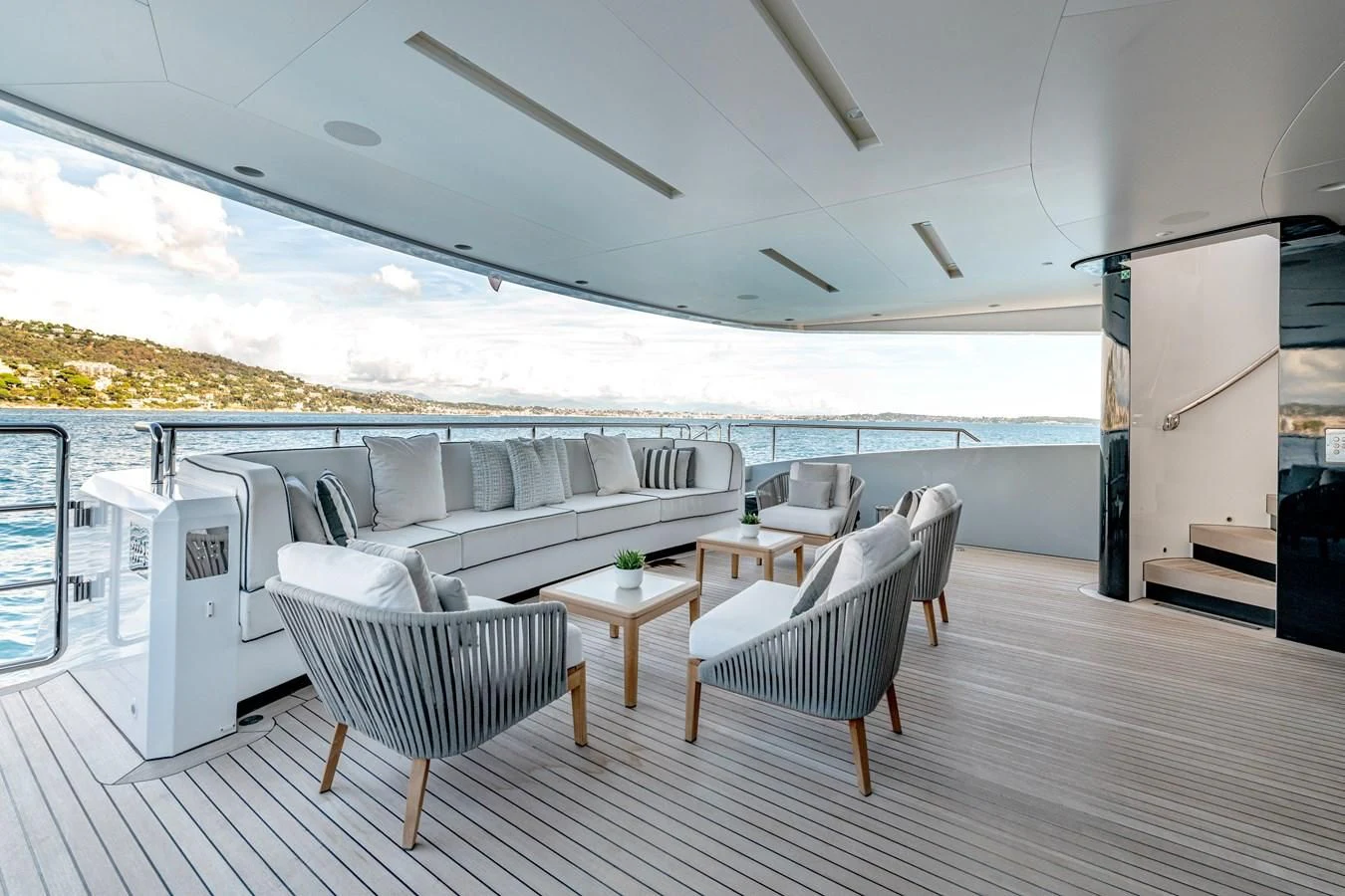 a large white living room with a large balcony and a large body of water aboard MEDIALLY Yacht for Sale
