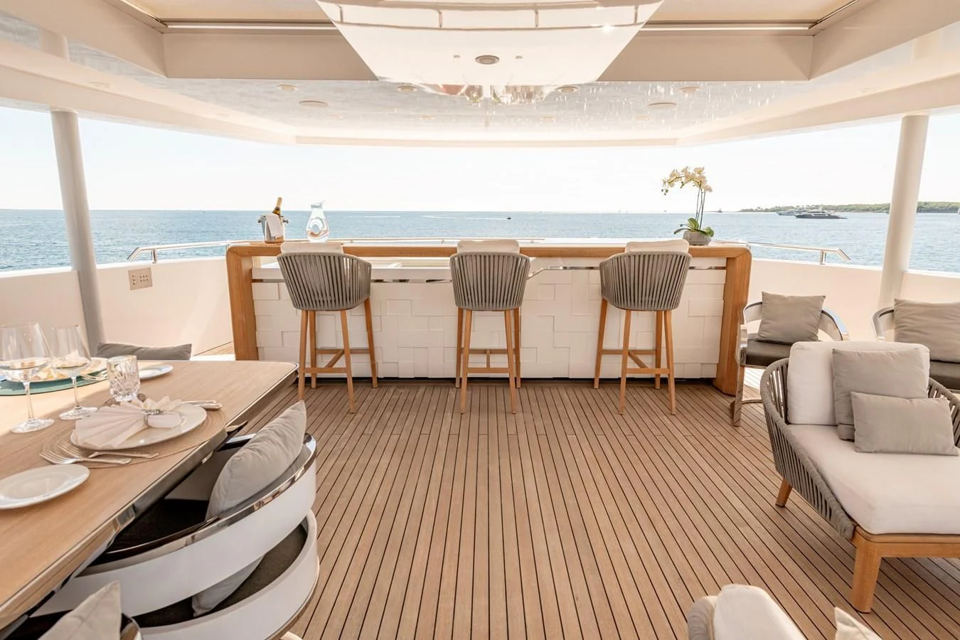 a room with a table chairs and a large body of water aboard MEDIALLY Yacht for Sale
