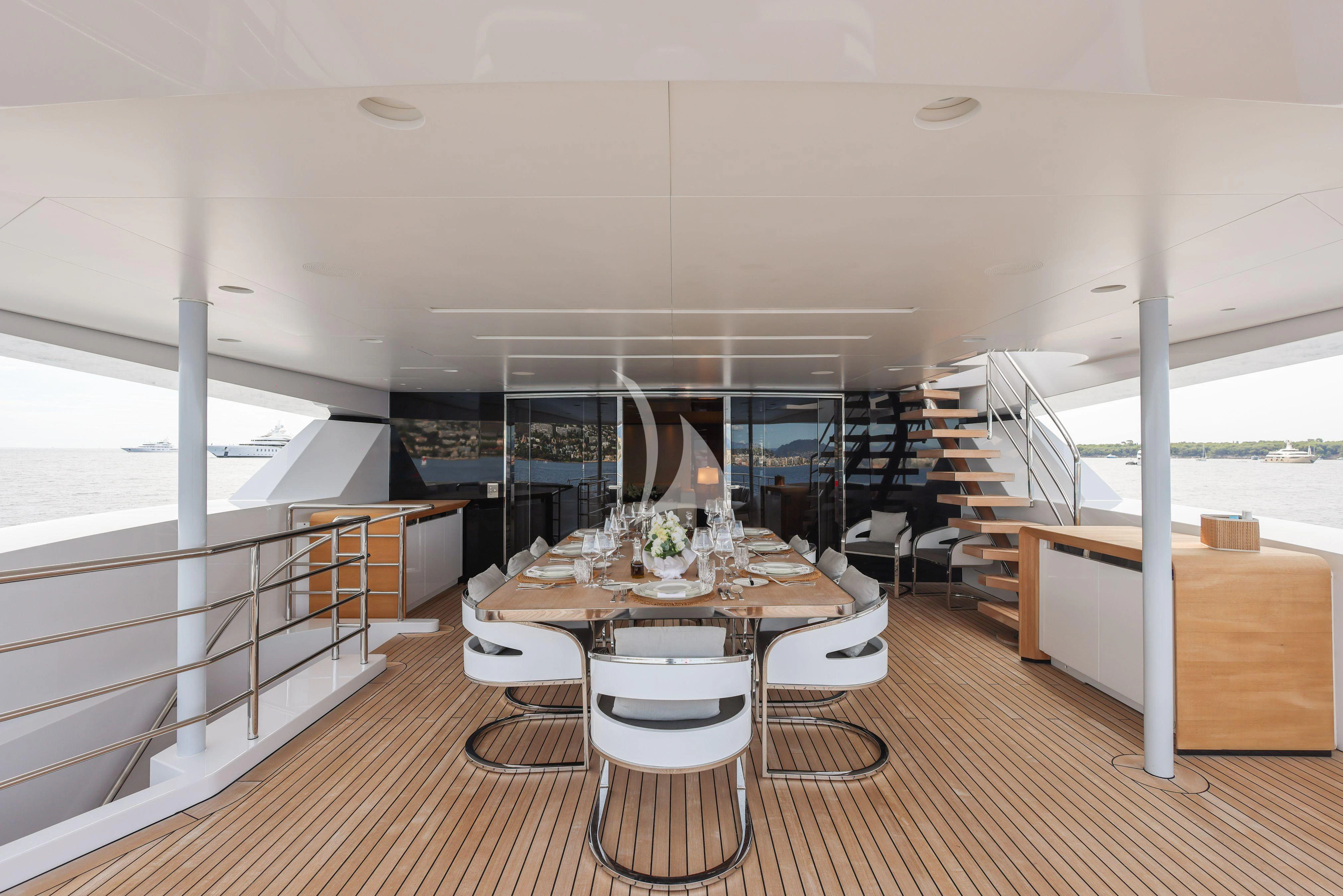a room with a table and chairs aboard MEDIALLY Yacht for Sale