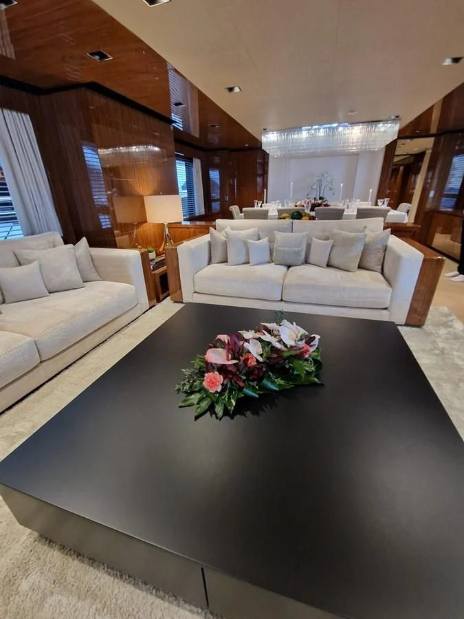 a living room with a large table aboard MEDIALLY Yacht for Sale