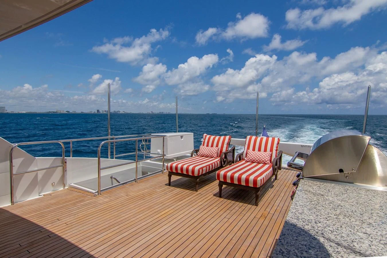 a deck with chairs on it overlooking the ocean aboard BRAVO Yacht for Sale