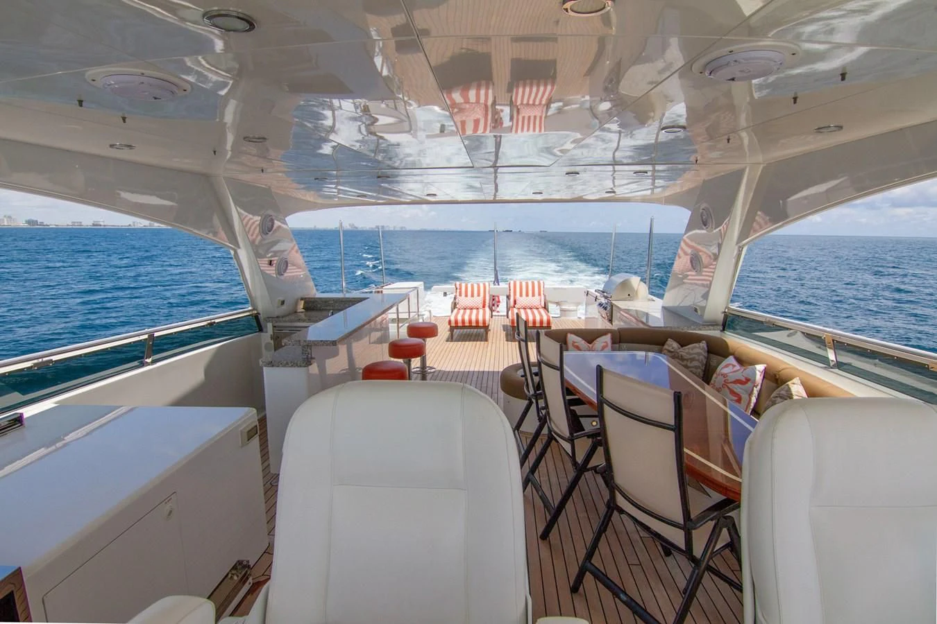 a boat with a deck and chairs aboard BRAVO Yacht for Sale