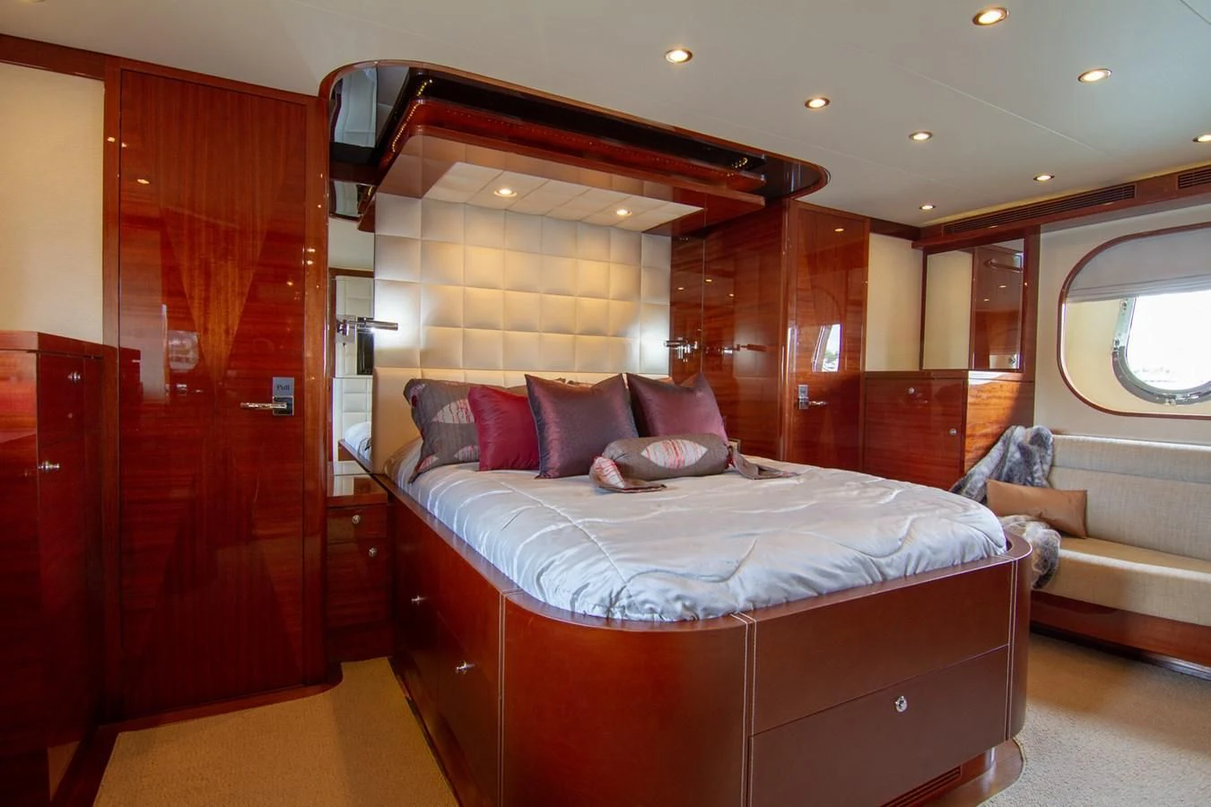 a room with a bed and a mirror aboard BRAVO Yacht for Sale