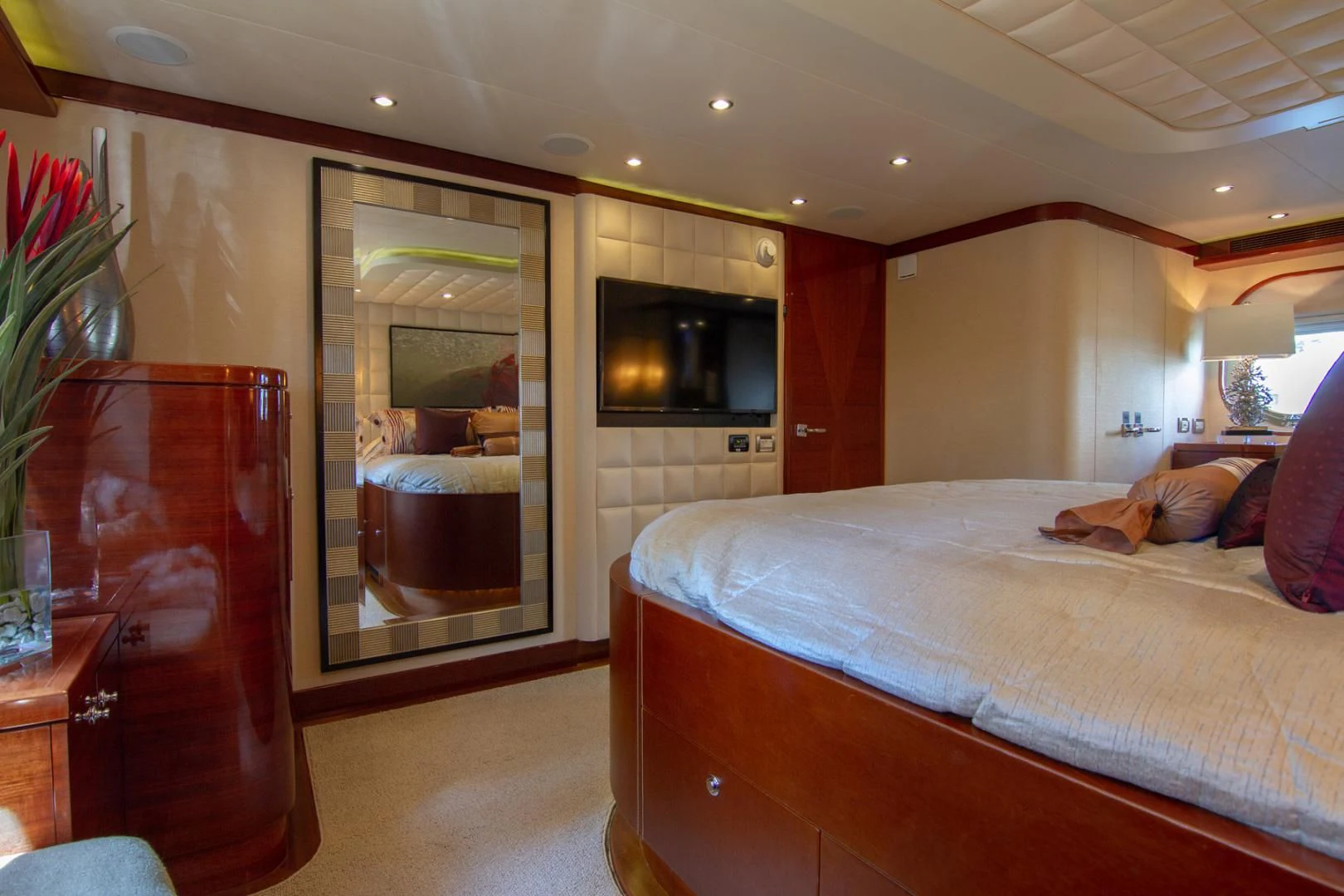 a bedroom with a bed and a television aboard BRAVO Yacht for Sale