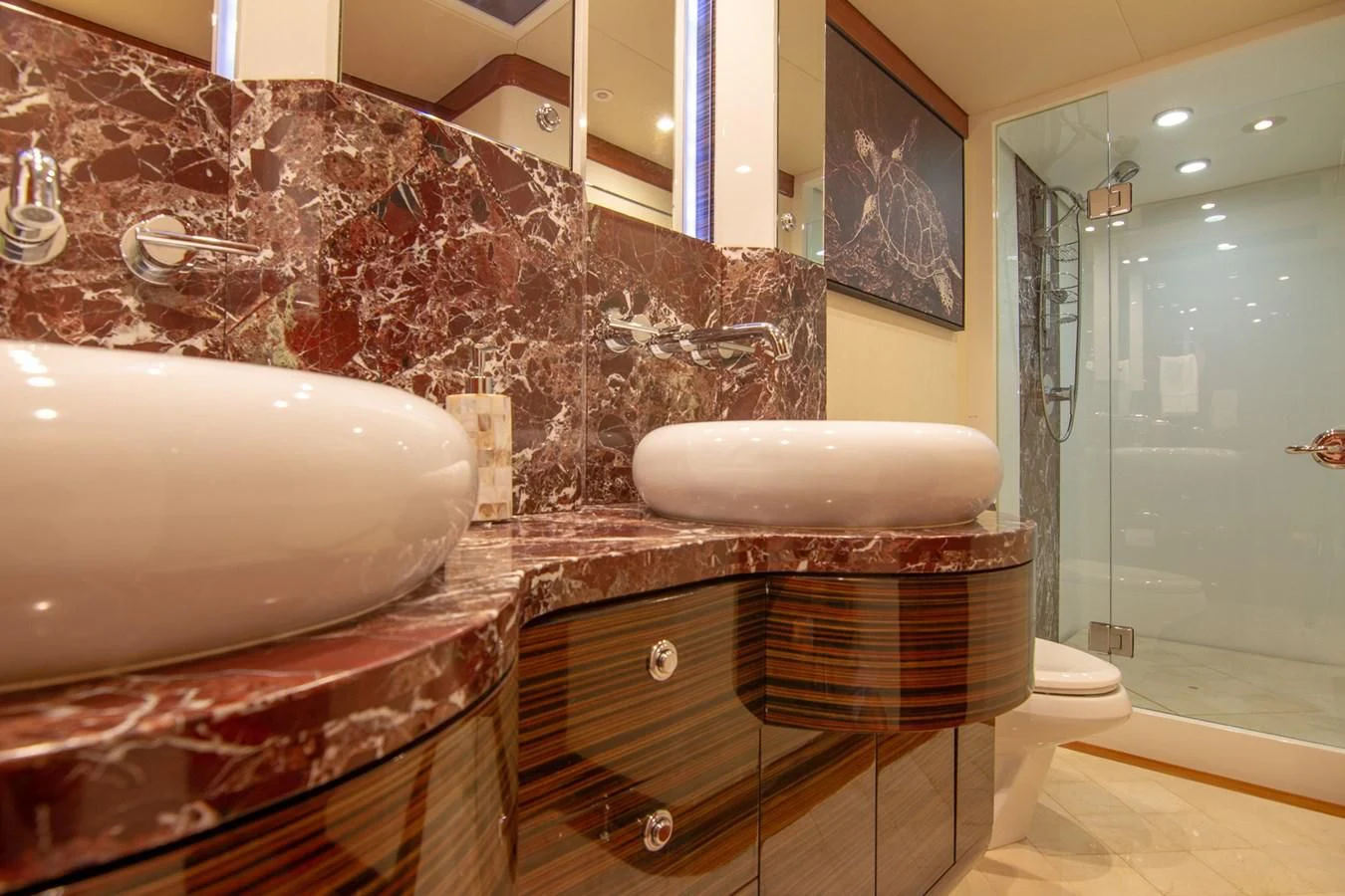 a large bathroom with a large mirror aboard BRAVO Yacht for Sale
