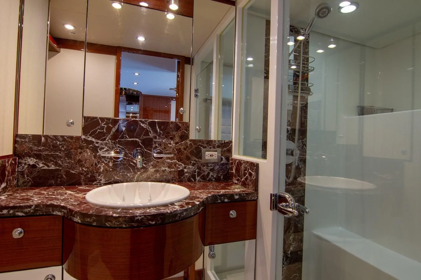 a bathroom with a large mirror aboard BRAVO Yacht for Sale