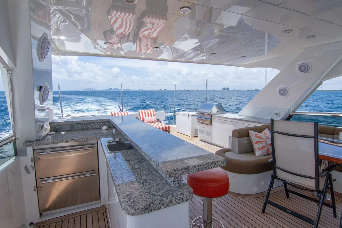 a room with a table chairs and a large window aboard BRAVO Yacht for Sale