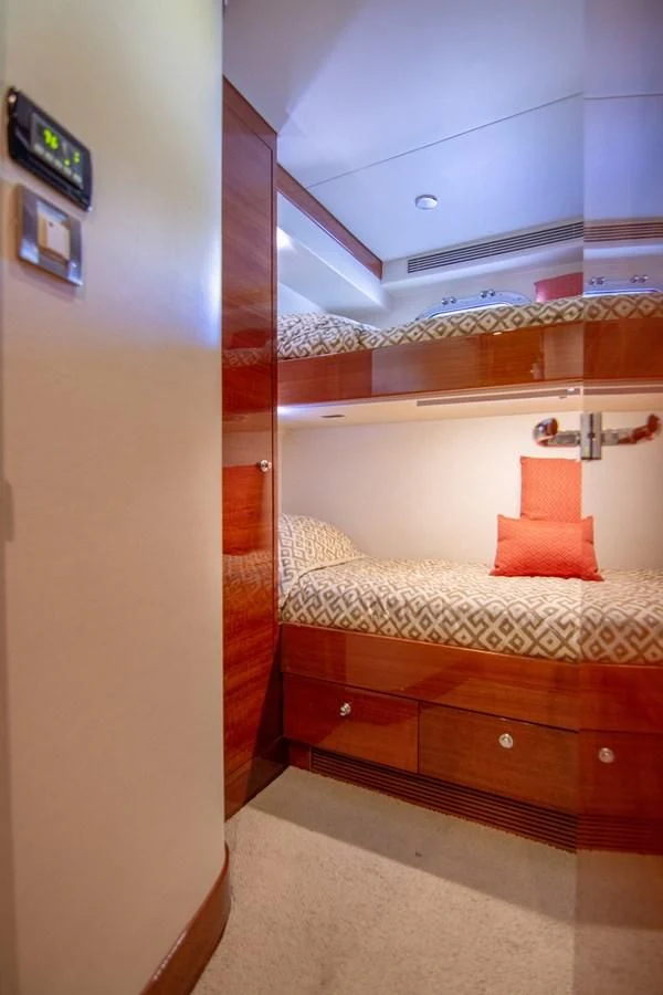 a bed with a wooden frame aboard BRAVO Yacht for Sale