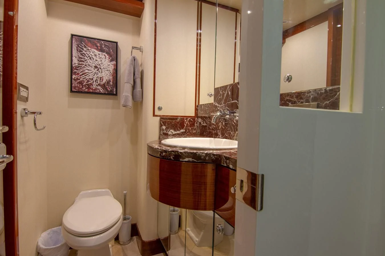 a bathroom with a sink toilet and a mirror aboard BRAVO Yacht for Sale