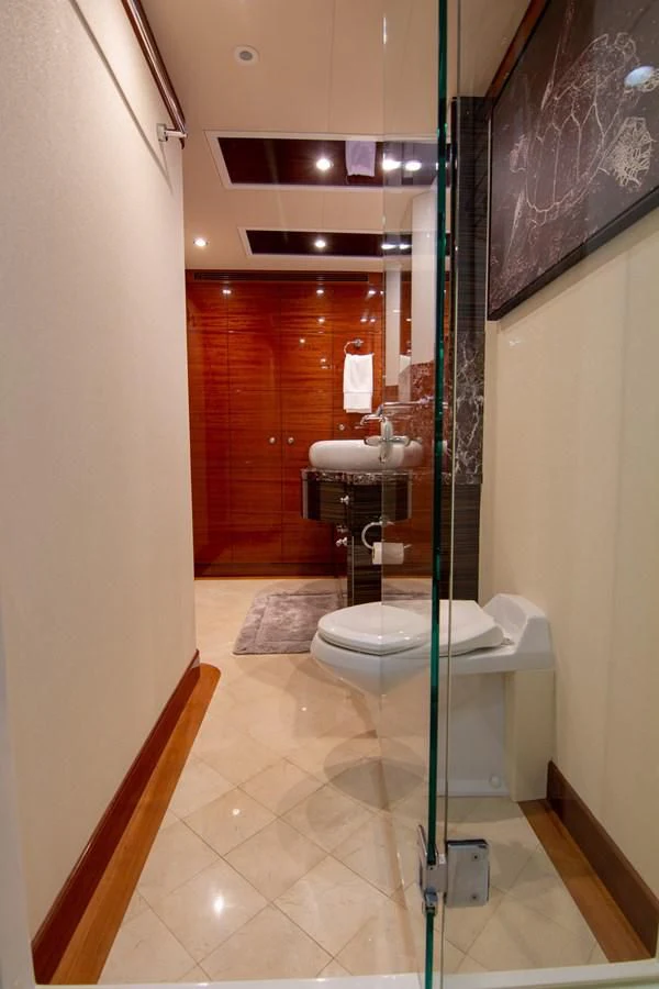 a bathroom with a glass shower aboard BRAVO Yacht for Sale