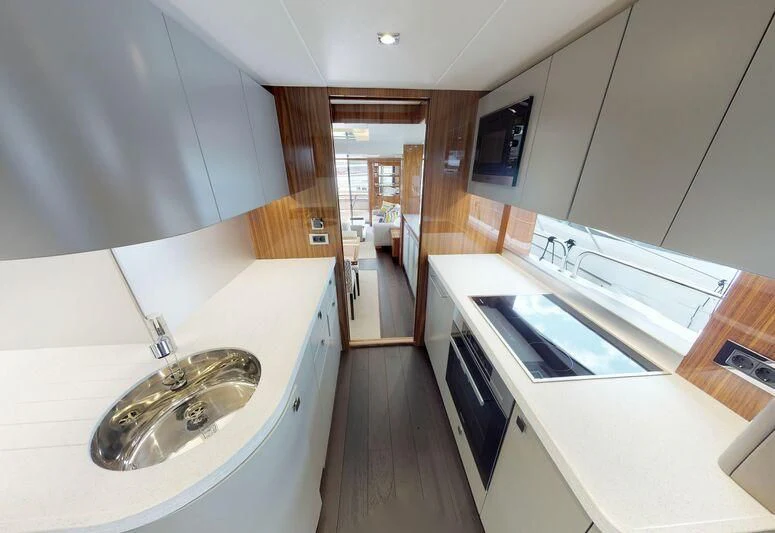 a kitchen with a sink and a large window aboard SEA WATER II Yacht for Sale