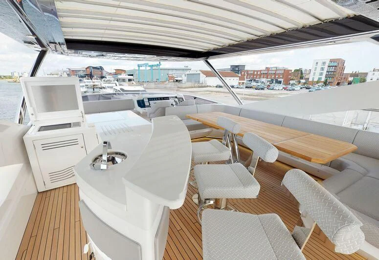 a room with a table chairs and a view of a city aboard SEA WATER II Yacht for Sale