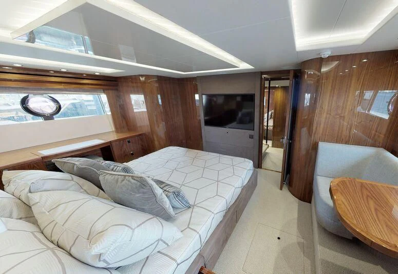 a bedroom with a bed and a chair aboard SEA WATER II Yacht for Sale