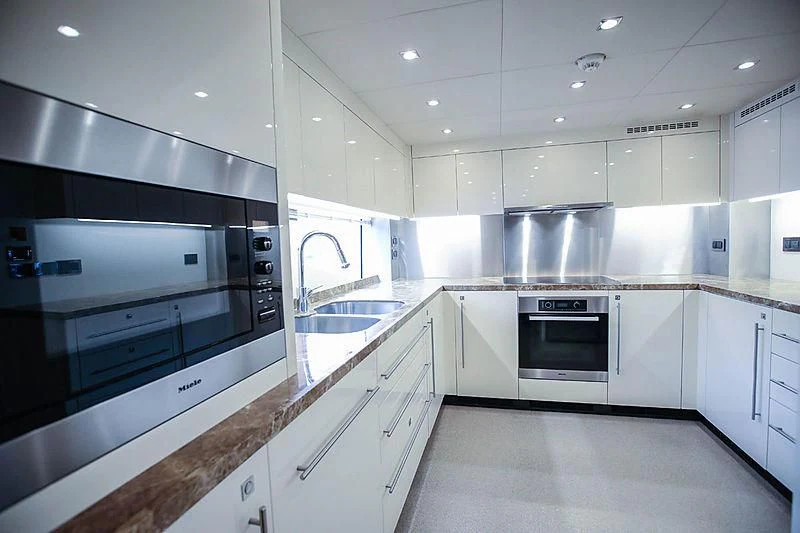 a kitchen with white cabinets aboard SUN GOLD Yacht for Sale
