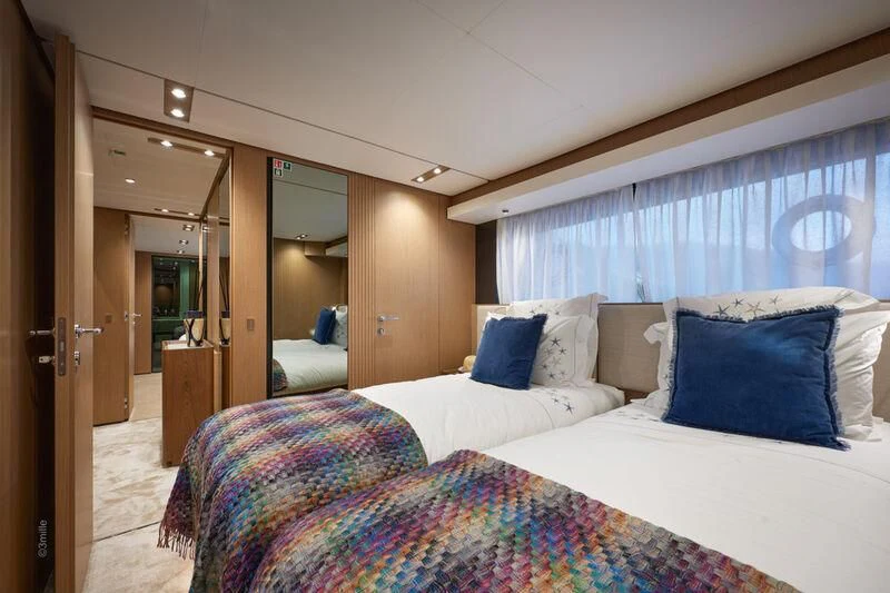 a bedroom with a bed and a door aboard SPICA Yacht for Sale
