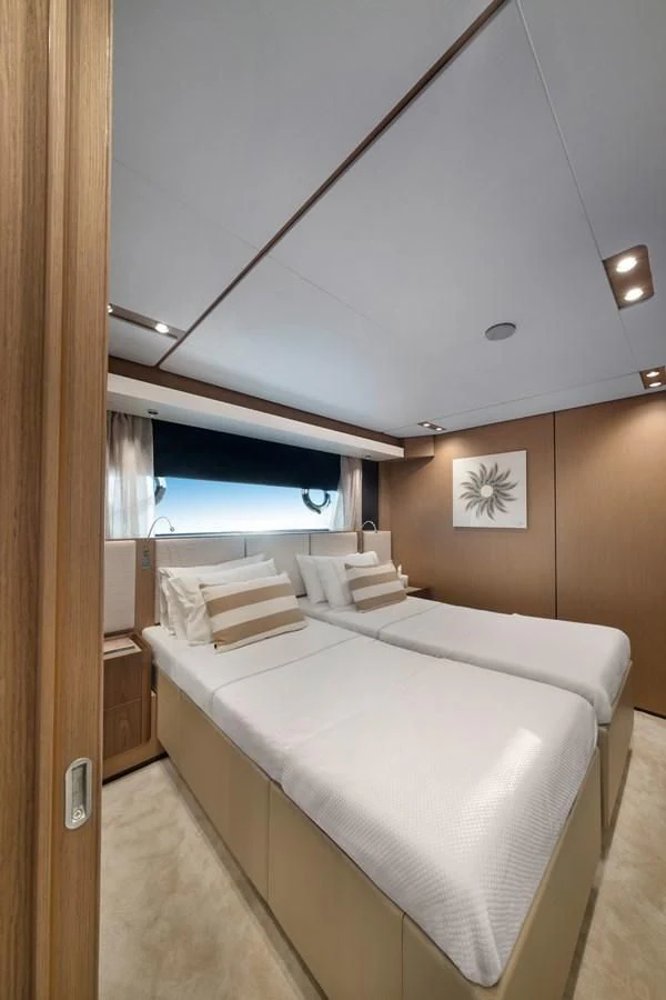 a room with a bed and a window aboard SPICA Yacht for Sale