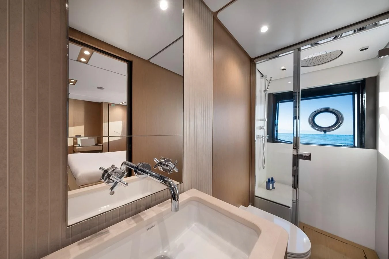 a bathroom with a large mirror aboard SPICA Yacht for Sale