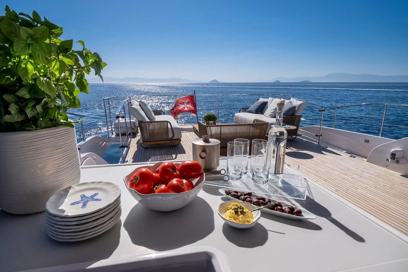 a table with food and drinks on it aboard SPICA Yacht for Sale