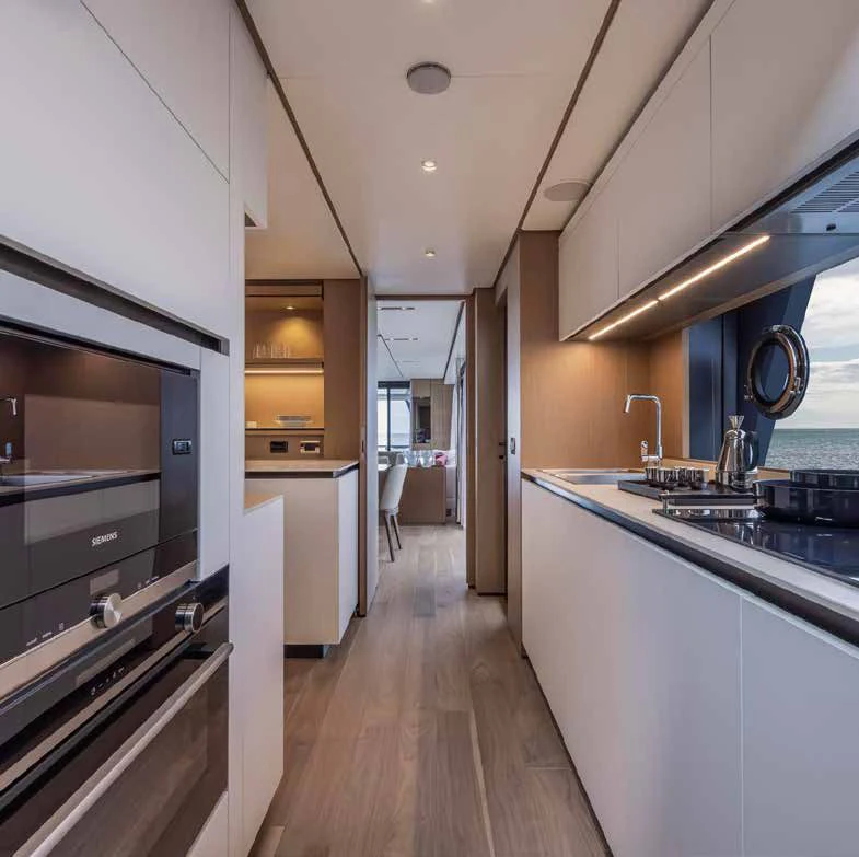 a kitchen with a wood floor aboard SPICA Yacht for Sale