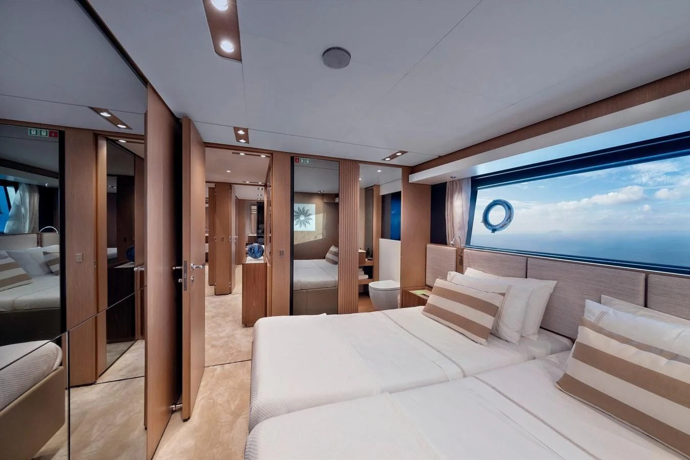a room with a bed and a window aboard SPICA Yacht for Sale