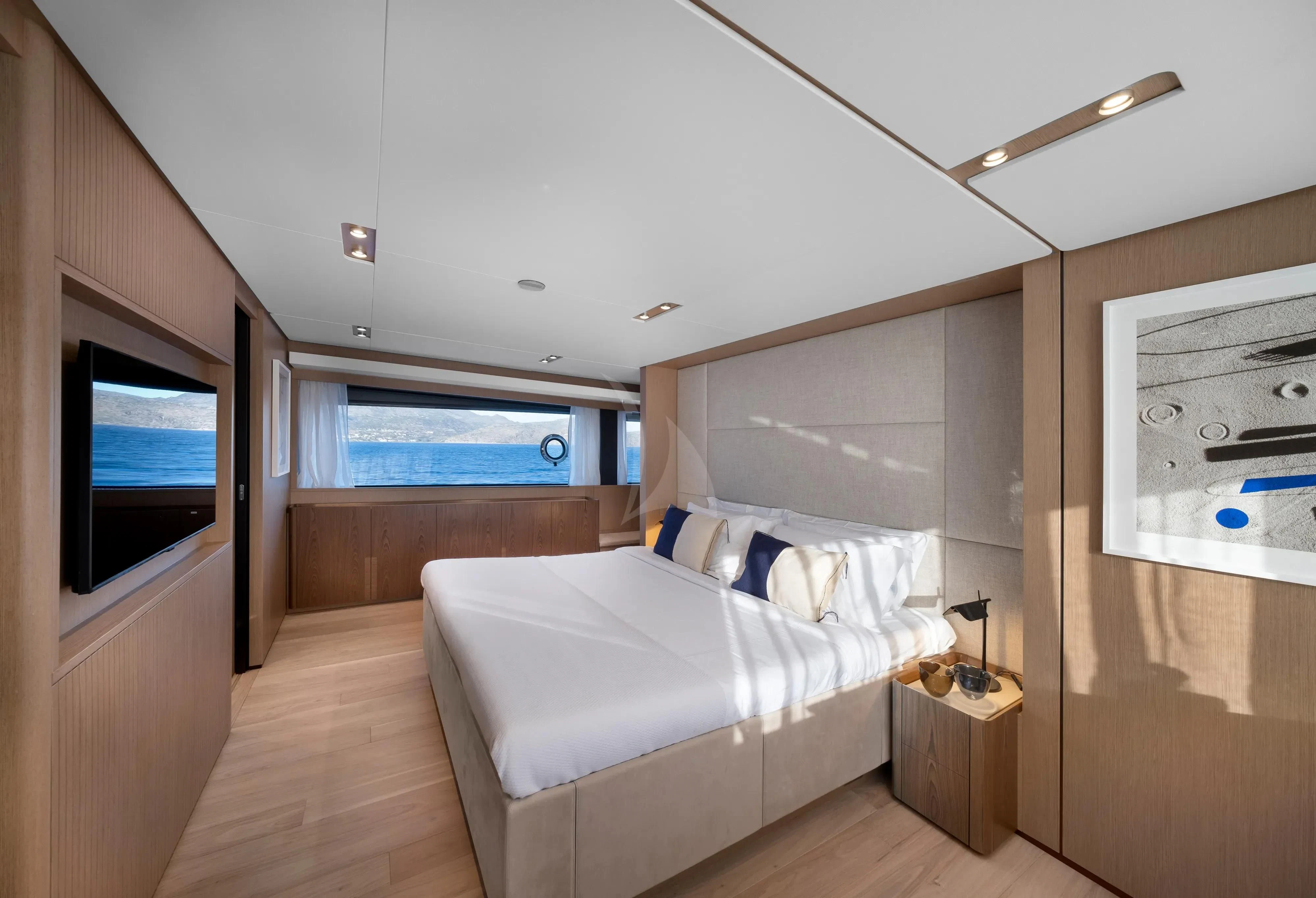 a bedroom with a bed and a tv aboard SPICA Yacht for Sale