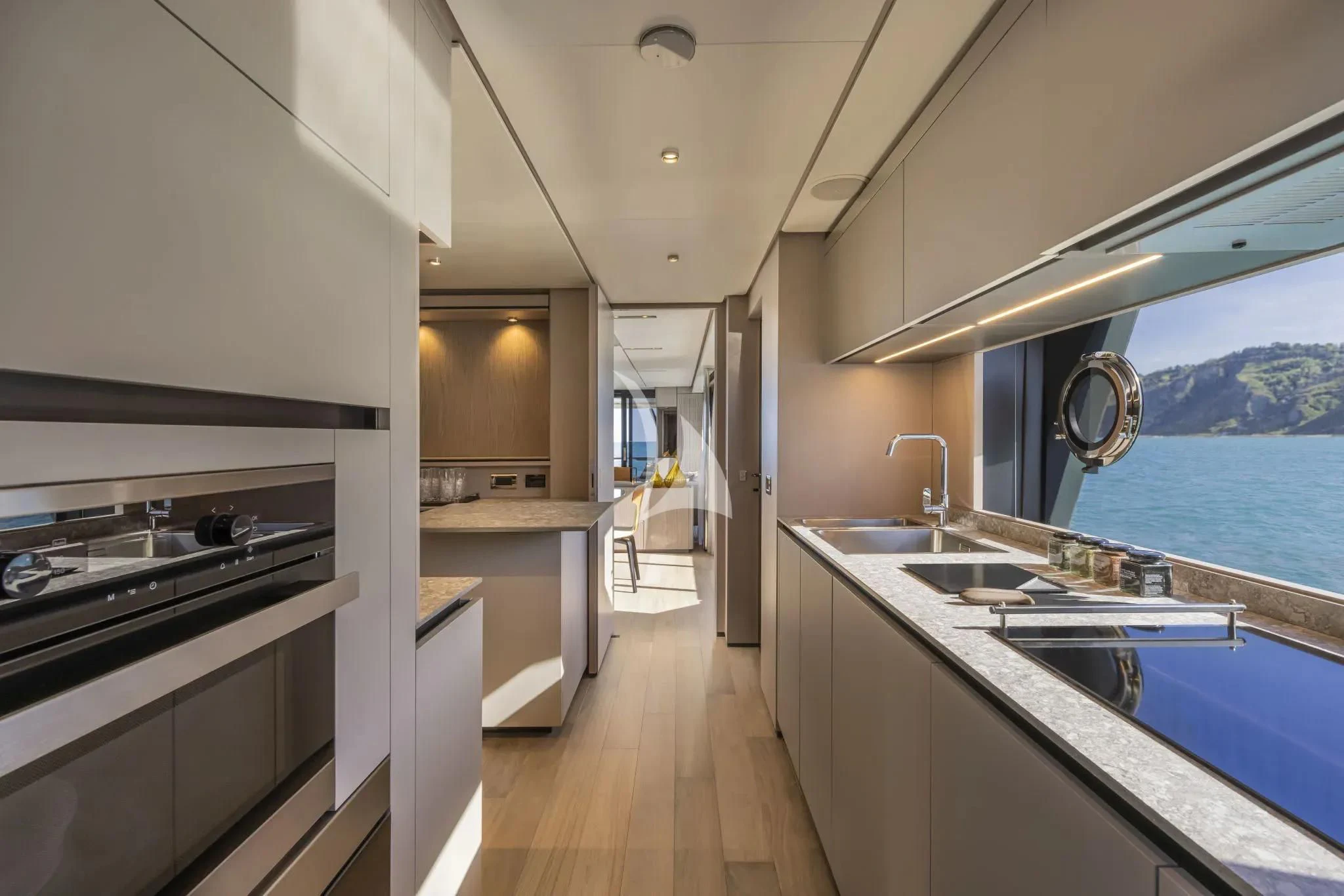 a kitchen with a large window aboard SPICA Yacht for Sale