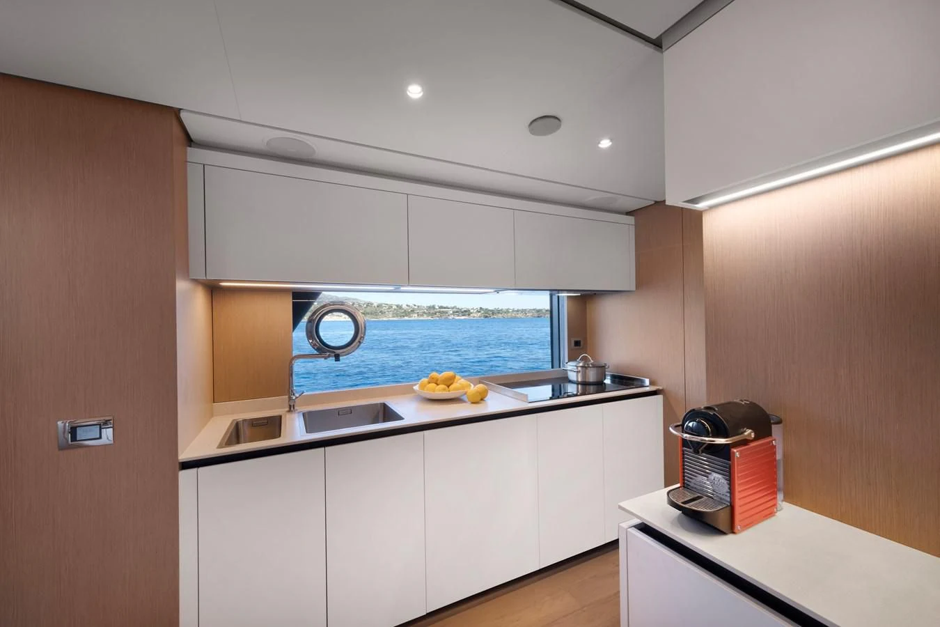a kitchen with a large window aboard SPICA Yacht for Sale