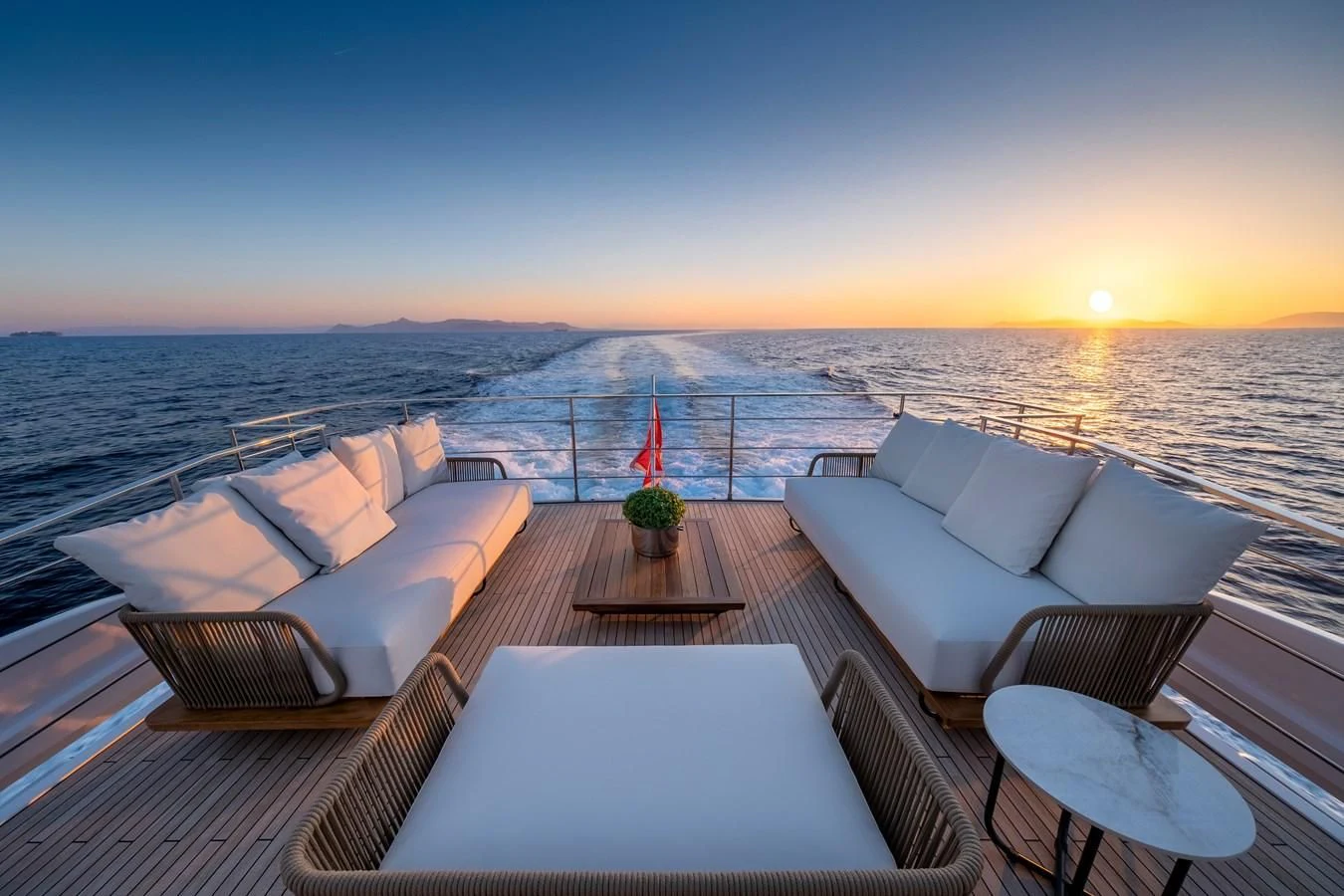 a balcony overlooking a sunset aboard SPICA Yacht for Sale