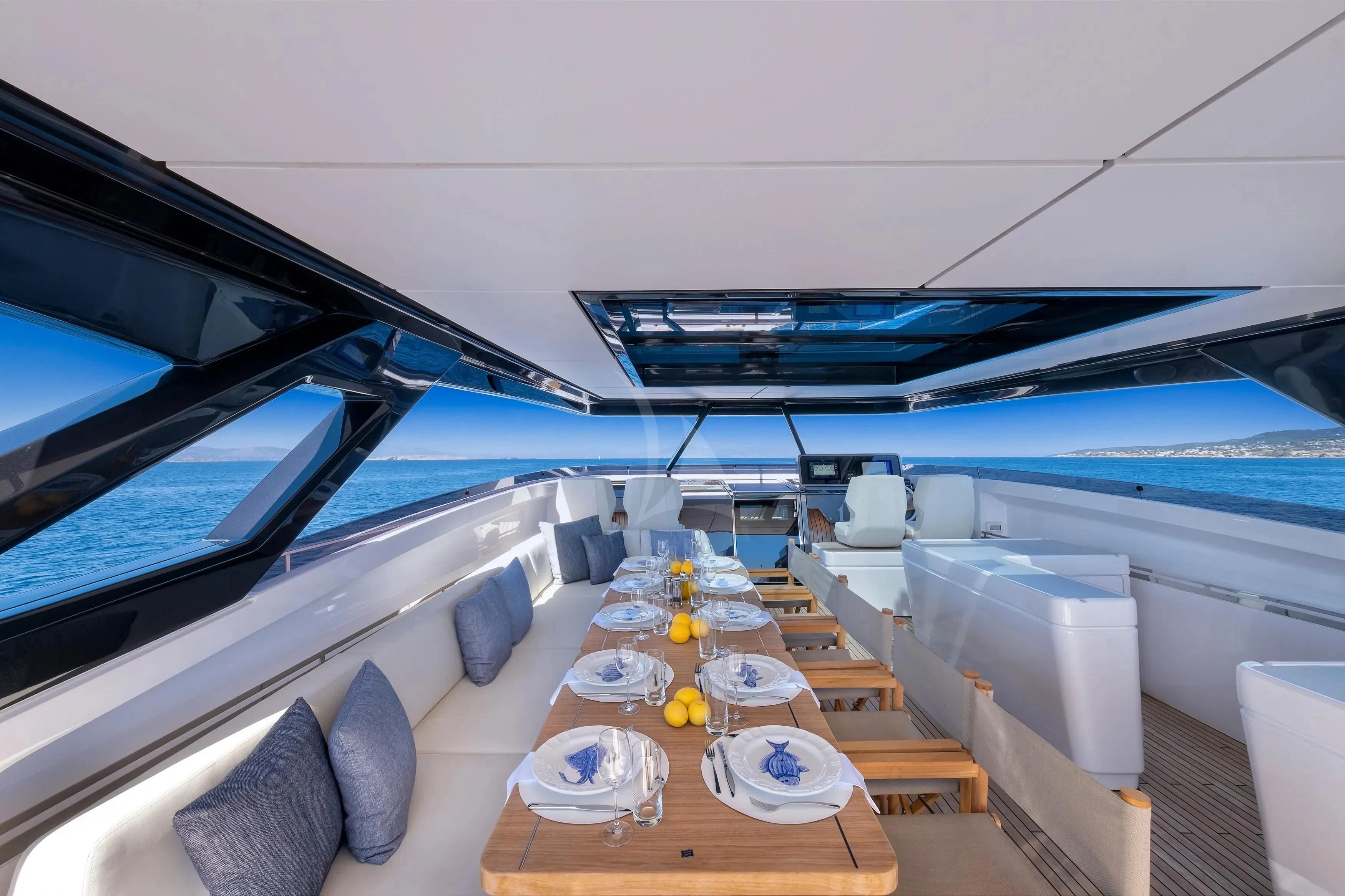 a room with a table and chairs aboard SPICA Yacht for Sale