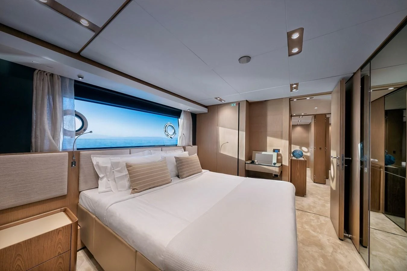 a room with a bed and a window aboard SPICA Yacht for Sale
