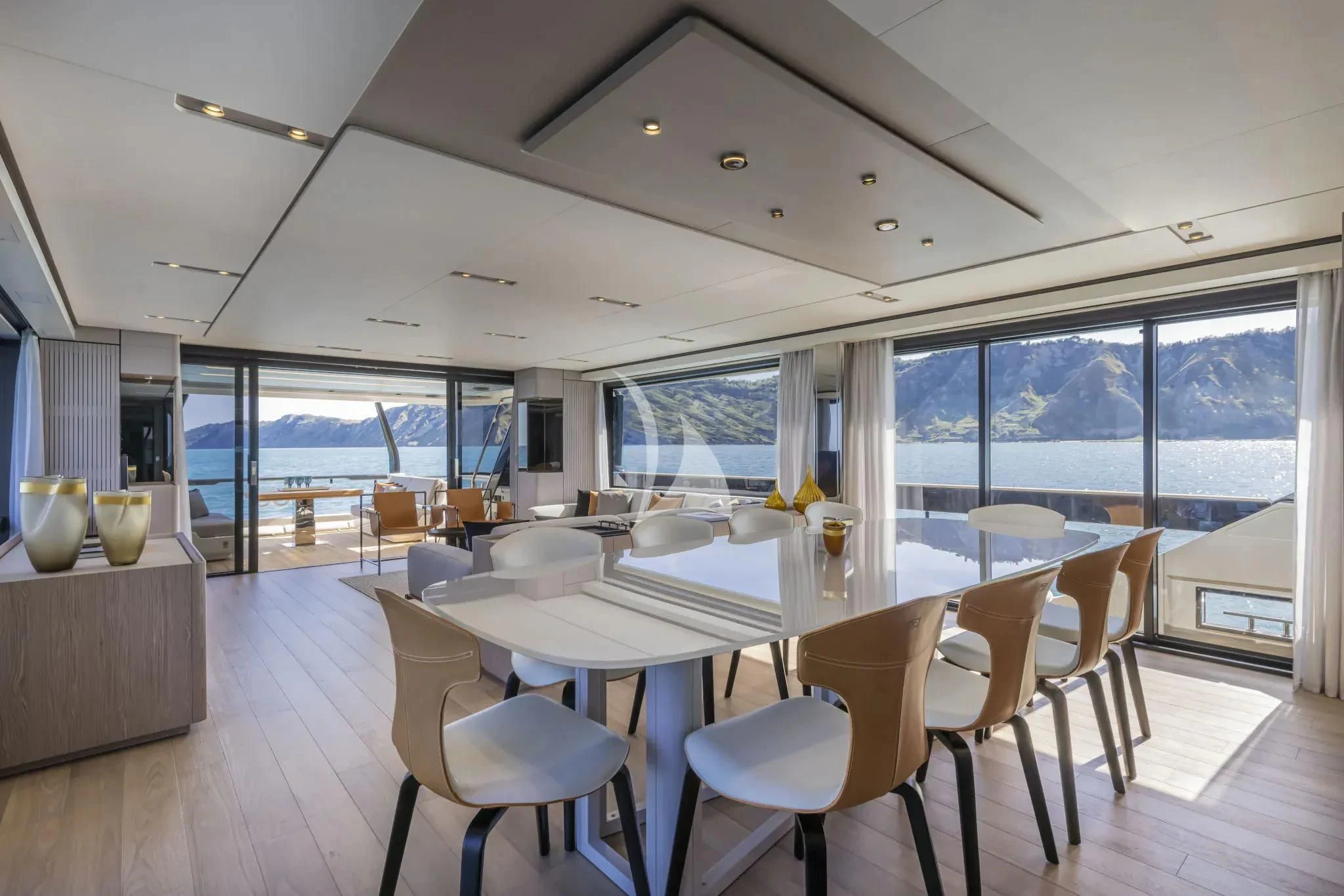 a room with tables and chairs aboard SPICA Yacht for Sale