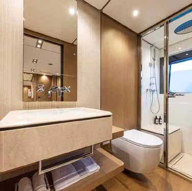 a bathroom with a tub and a sink aboard SPICA Yacht for Sale