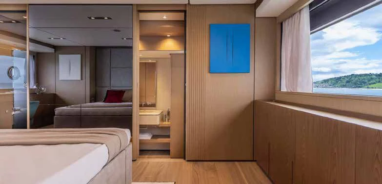 a room with a bed and a window aboard SPICA Yacht for Sale