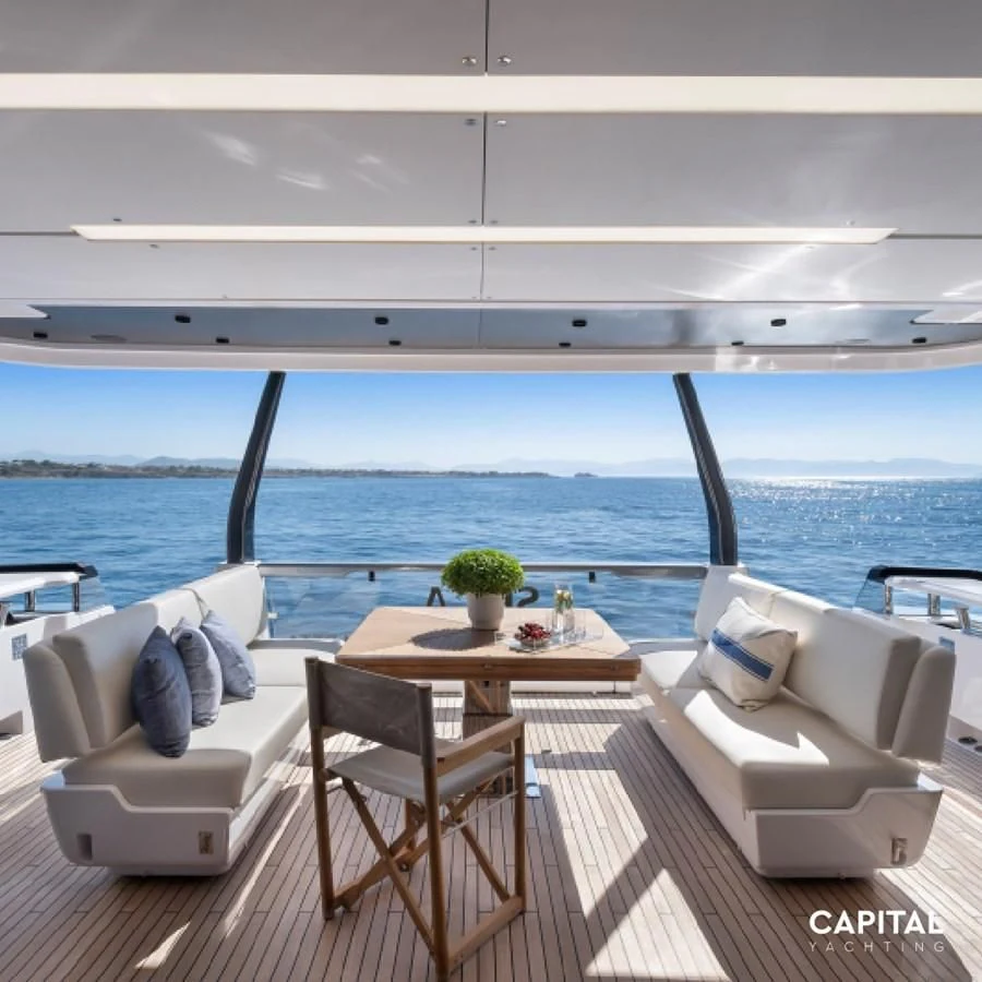 a room with a table and chairs aboard SPICA Yacht for Sale
